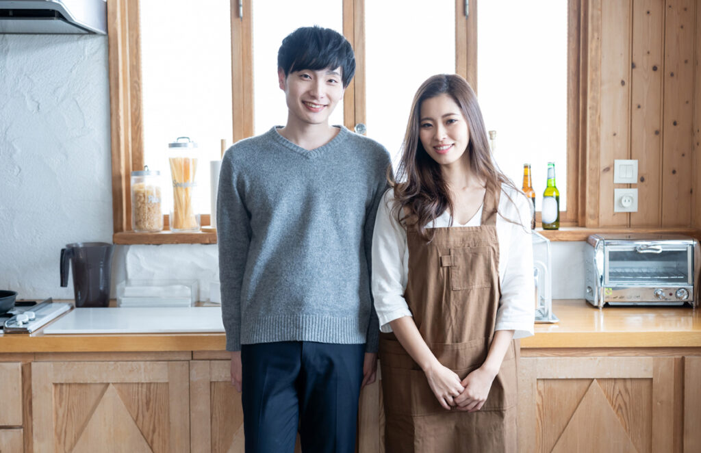 キッチンで寄り添う夫婦のイメージ